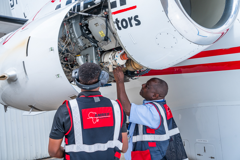 AMREF technicians inspecting engine